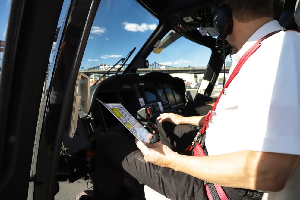A HeliFlite pilot performing a safety check before a private helicopter charter
